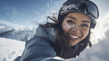 Joyful woman with snow on face enjoying winter sports.