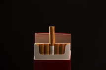 pack of cigarettes against a black background