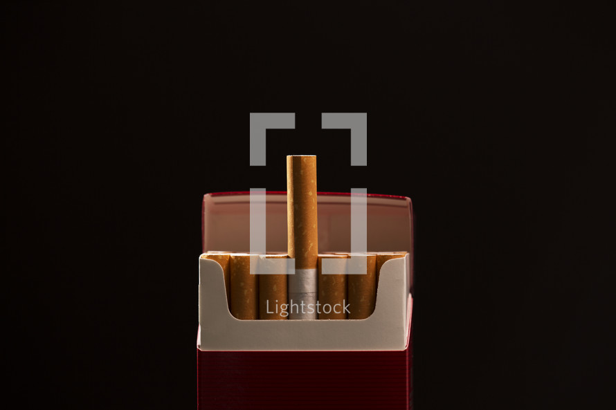 pack of cigarettes against a black background
