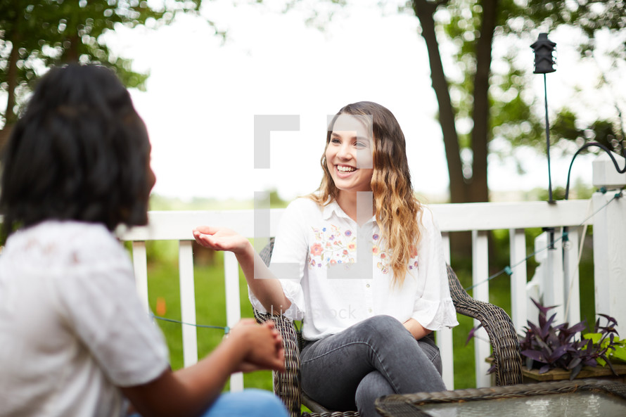 women talking on a patio 