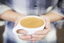 woman holding a cup of coffee 