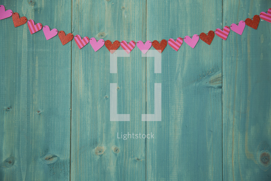 heart banner on a teal wall 