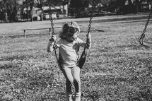 child on a swingset 