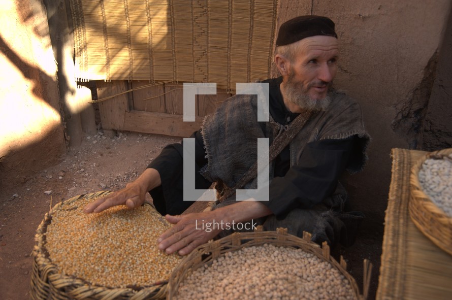 A man selling grains in the market in biblical times 