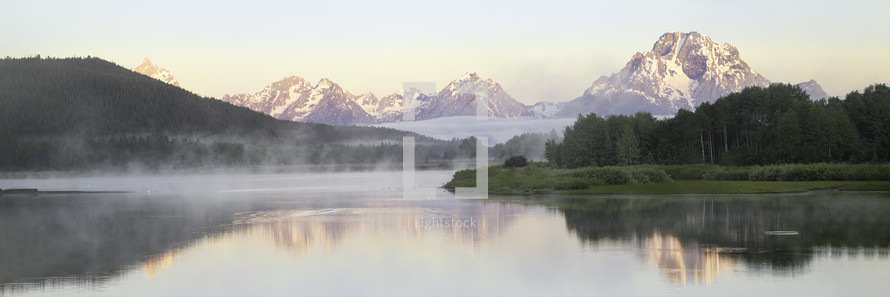 Fog rolls in on the snake river at Oxbow Bend at sunrise. Oxbow Bend is located in Grand teton National Park
