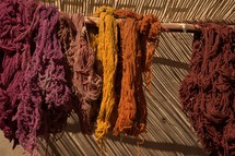 dyed yarns hanging at a market in biblical times 