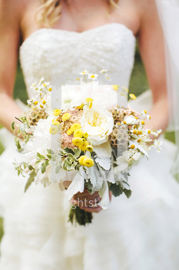 torso bride holding a bouquet of flowers