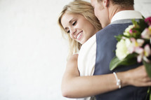 young bride and groom hugging. 