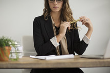 a businesswoman sitting behind a desk 