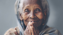 Portrait of Indian African aged smiling woman with a headscarf looking in camera.