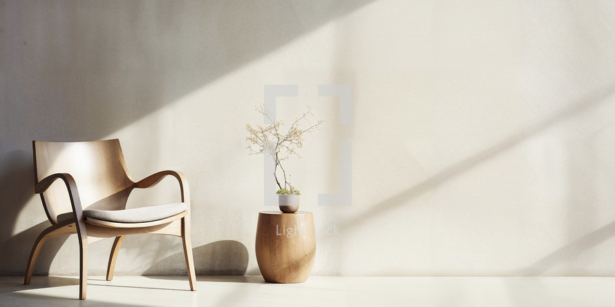 Stylish modern chair with organic wooden side table against a warm, sunlit wall.