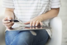 a woman holding a credit card and shopping online 