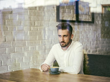 a man sitting alone in a coffee shop 