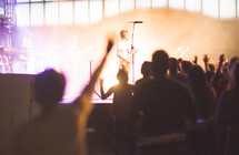 a band on stage and audience at a concert 