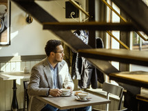 a man sitting at a cafe 