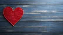 Red leather heart on blue blurred jeans background. Gratefulness or appreciation concept.