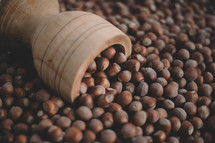 Hazelnuts in a wooden bowl on rustic background