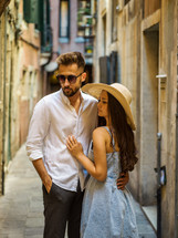 a couple standing in an alley 