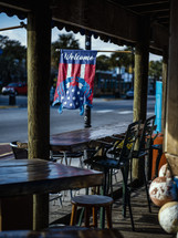 welcome flag at a restaurant with outdoor seating 