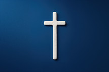 Minimalist white cross on a solid blue background, symbolizing Christian faith, purity, and devotion. Ideal for religious themes and spiritual messages.