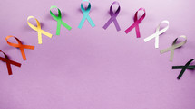 World cancer awareness day ribbons on pink background copy space