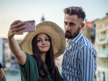 a couple traveling together taking selfies 