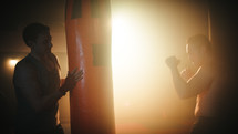 Silhouette of Boxing fighter training in the gym