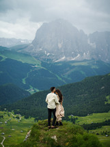 engagement portrait on a green mountainside 