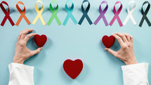 Heart symbols and ribbons for world cancer awareness day
