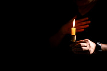 Bible and candlelight with praying hands