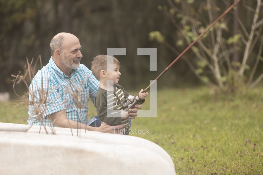 grandfather and grandson fishing together 
