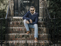 a man sitting on brick steps 
