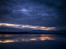 purple clouds reflecting on lake water 