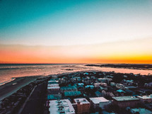 aerial view over a coastal town at sunset 
