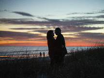 silhouette of a couple on a beach at sunset 