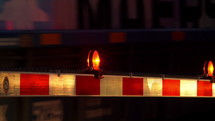 A railroad crossing gate at night with a passing train