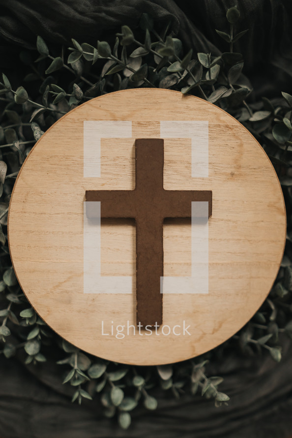 cross on a wooden circle 