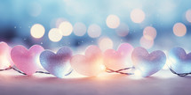 Christmas background with colorful hearts garland and glitter light bokeh.