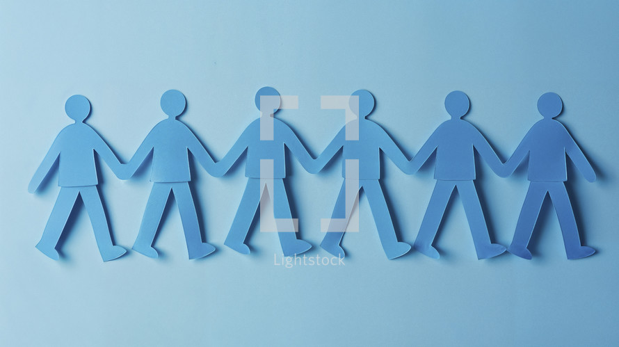 Blue paper cutout figures holding hands, symbolizing unity and teamwork on a light blue background.