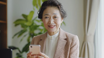 Senior businesswoman with smartphone, embracing technology.