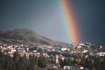 A rainbow in a sunny blue sky