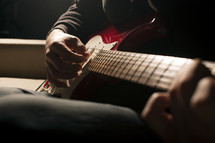 Close-up of someone playing a guitar.