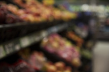 blurry image of the produce section of a grocery store 