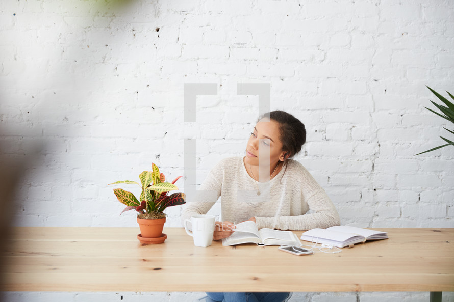 woman sitting at a desk with a Bible 
