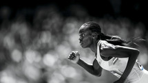 Focused sprinter in mid-race at the Olympics.