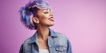 Radiant woman with short pastel purple hair, denim jacket, and red lipstick, against a pink background.