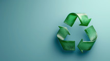 Green recycling symbol on a light blue background, emphasizing sustainability and environmental awareness. Perfect for eco-friendly and recycling-themed projects.