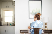 a woman sitting at a desk with a coffee mug
