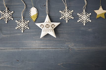 snowflake and star ornament on a wooden background.