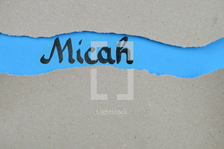 Micah - torn open kraft paper over blue paper with the name of the prophetic book Micah